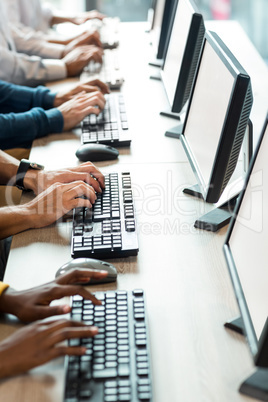 Mid section of colleagues working on computer