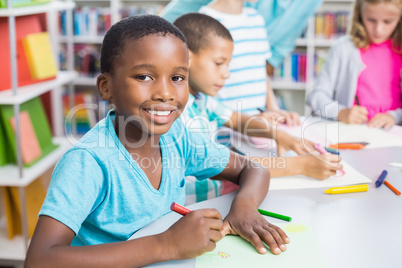 Portrait of schoolboy in library