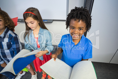 Kids reading book in classroom