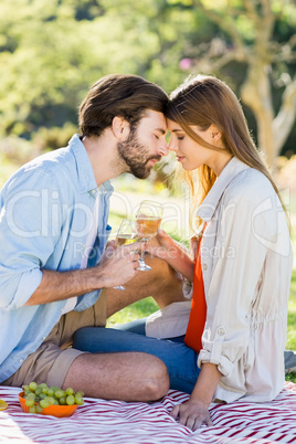 Portrait of couple holding glass of wine