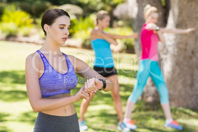 Woman checking time while exercising