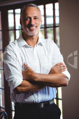 Smiling man with arms crossed