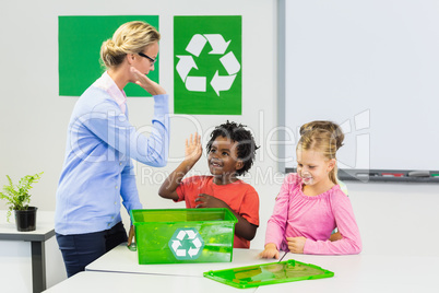 Teacher and kids giving high five to kids