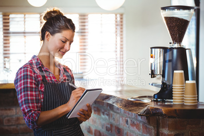 Waitress writing in a book