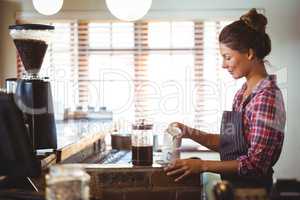 Waitress preparing a coffee