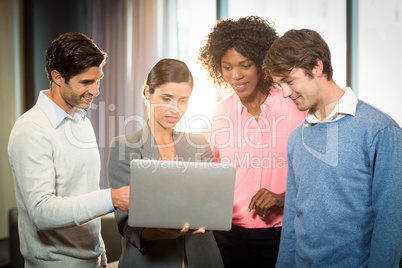 business people having discussion over laptop