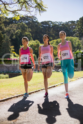 Female athletes warming up in park