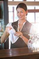 Waitress cleaning glasses