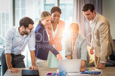 Group of business people interacting using laptop