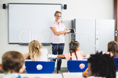 Teacher teaching kids on digital tablet