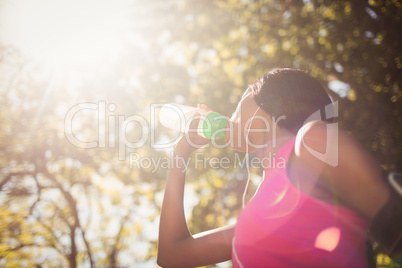 Low angle view of sporty woman drinking water
