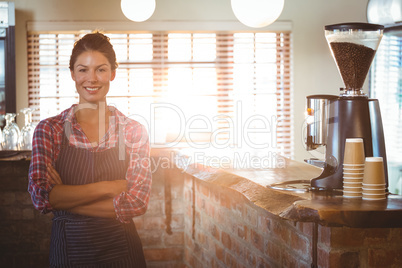 Waitress standing with arms crossed