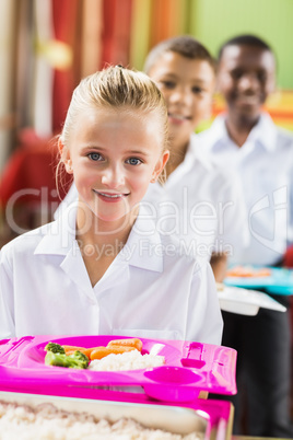 Portrait of schoolgirl having lunch during break time