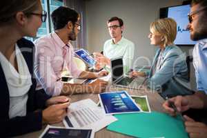 Business people discussing over graph during a meeting