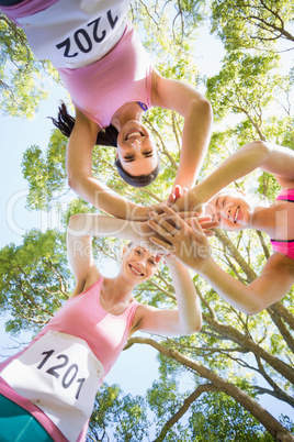 Young athlete women forming hands stack