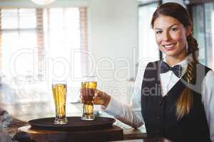 Waitress holding a beer