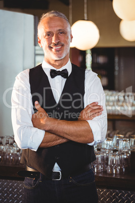 Portrait of bartender standing with arms crossed Portrait of bartender standing with arms crossed