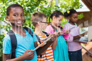 Kids using digital tablet and laptop at school