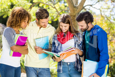 Group of college friends discussing the notes