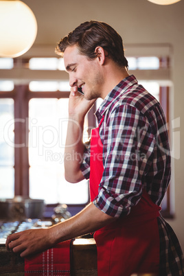 Waiter talking on mobile phone