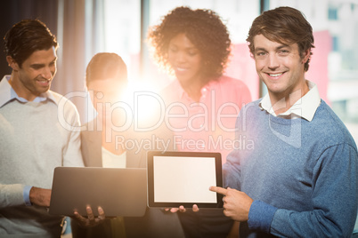 Businessman holding digital tablet with coworker