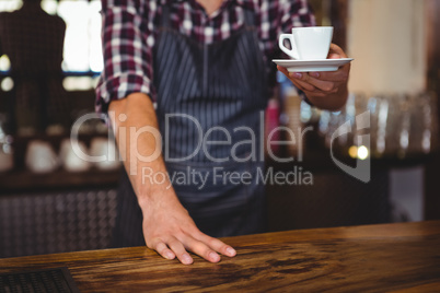 Waiter handing over a coffee