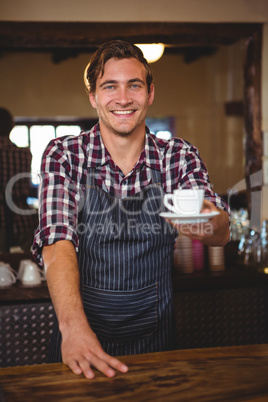 Waiter handing over a coffee