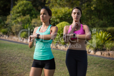 Beautiful women checking a time on wristwatch