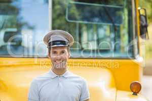 Bus driver smiling in front of bus