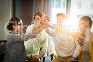 Business people giving high five to each other