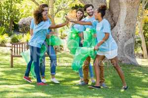 Group of volunteer having fun while collecting rubbish