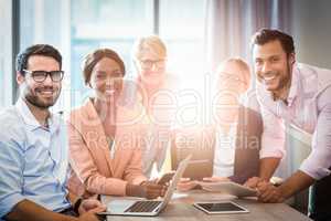 Business people holding laptop, mobile phone and digital tablet