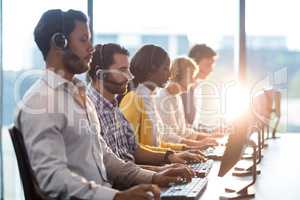 Team of colleagues working at their desk with headset