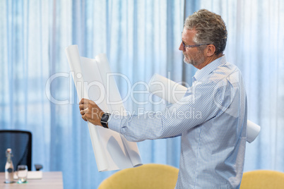 Man looking at blueprint