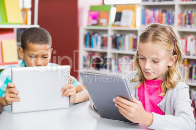 Kids using digital tablet in library