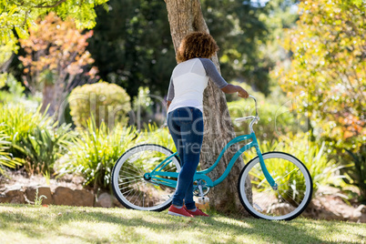 Rear view of woman parking her bicycle