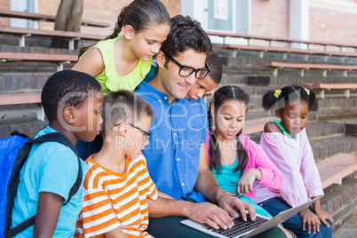 Teacher and kids using digital tablet