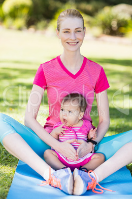 Woman exercising with her baby