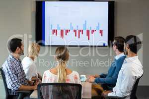 Business people discussing over graph during a meeting