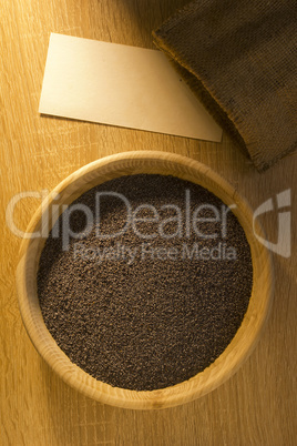 Poppy seeds in a wooden bowl