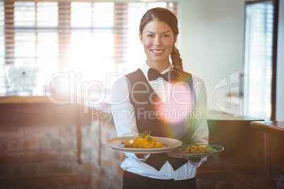 Waitress holding dishes