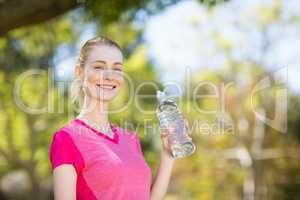 Portrait of woman holding water bottle
