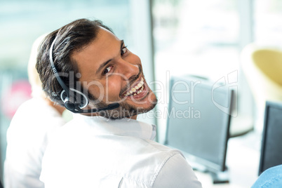 Young man working on computer with headset