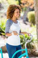 Woman walking with the cycle