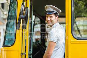 Bus driver smiling while entering in bus