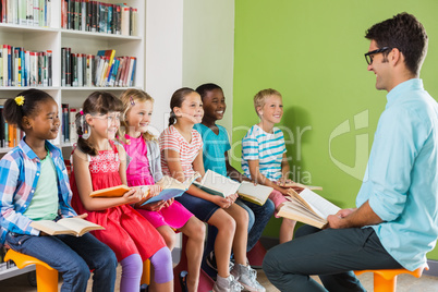 Teacher teaching kids in library