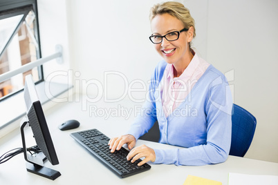 Teacher working on computer in classroom