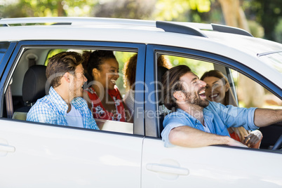 Group of friends having fun in car