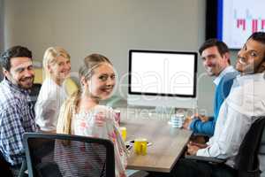 Business people smiling at camera during a video conference