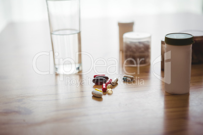 Close-up of medicine and a water glass
